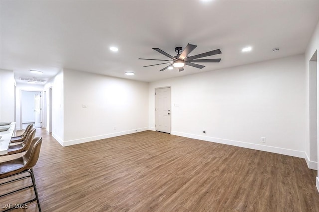unfurnished living room with baseboards, a ceiling fan, recessed lighting, and wood finished floors