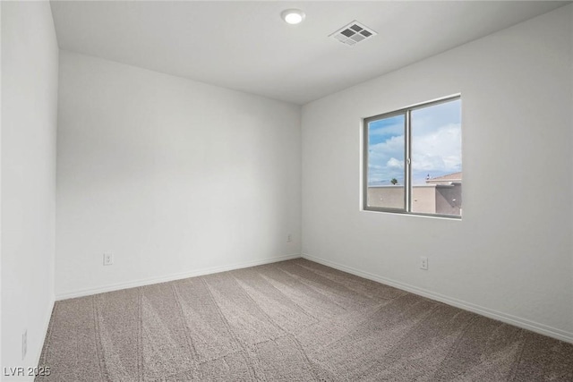 carpeted empty room with baseboards and visible vents