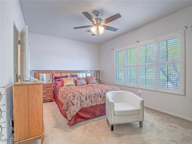 bedroom featuring light carpet, baseboards, and ceiling fan