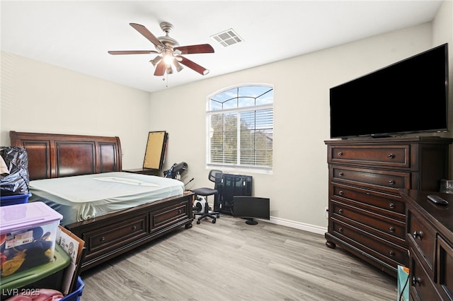 bedroom with baseboards, visible vents, ceiling fan, and light wood-type flooring