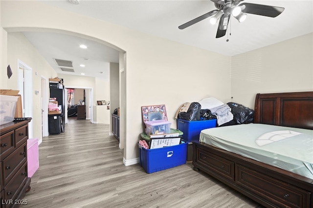 bedroom with visible vents, a ceiling fan, recessed lighting, arched walkways, and light wood finished floors