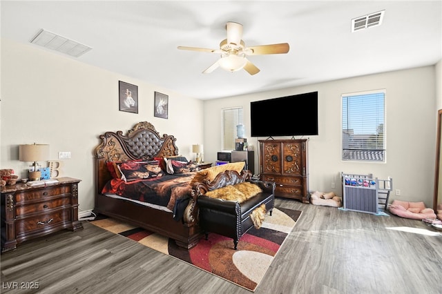 bedroom with multiple windows, wood finished floors, and visible vents