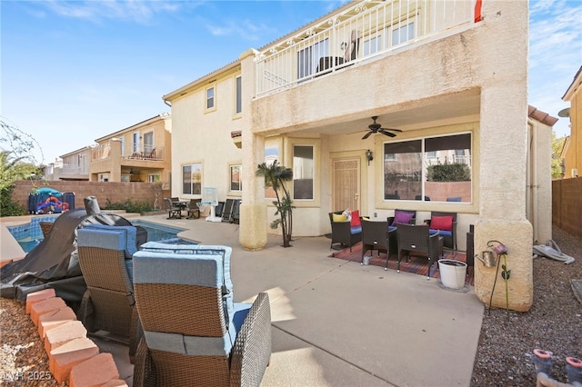 view of patio with ceiling fan, a balcony, a fenced backyard, an outdoor hangout area, and outdoor dining space