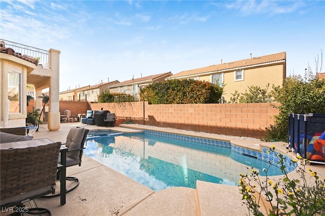 view of swimming pool featuring a fenced in pool, a fenced backyard, and a patio area