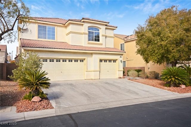 mediterranean / spanish home featuring a garage, a tiled roof, concrete driveway, and stucco siding