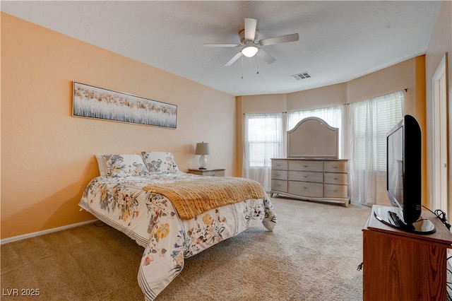 bedroom with carpet floors, ceiling fan, baseboards, and visible vents