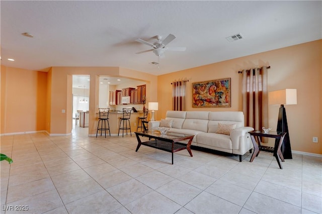 living area featuring ceiling fan, recessed lighting, baseboards, light tile patterned floors, and visible vents