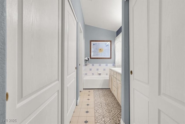 1861 Windward Ct, Henderson, NV 89012 - full bath featuring vanity, tile patterned flooring, vaulted ceiling, and a bath