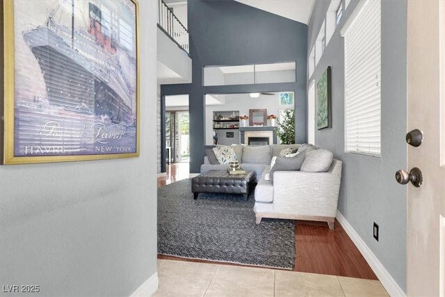 1861 Windward Ct, Henderson, NV 89012 - interior space with baseboards, a fireplace, tile patterned floors, and high vaulted ceiling