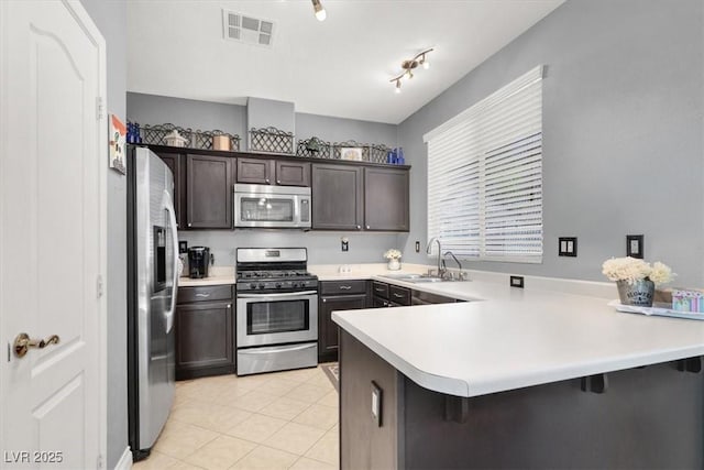 1861 Windward Ct, Henderson, NV 89012 - kitchen with visible vents, a sink, light countertops, a peninsula, and stainless steel appliances