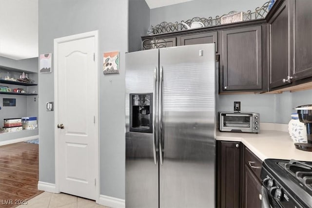 1861 Windward Ct, Henderson, NV 89012 - kitchen featuring dark brown cabinetry, light countertops, light tile patterned floors, a toaster, and stainless steel fridge
