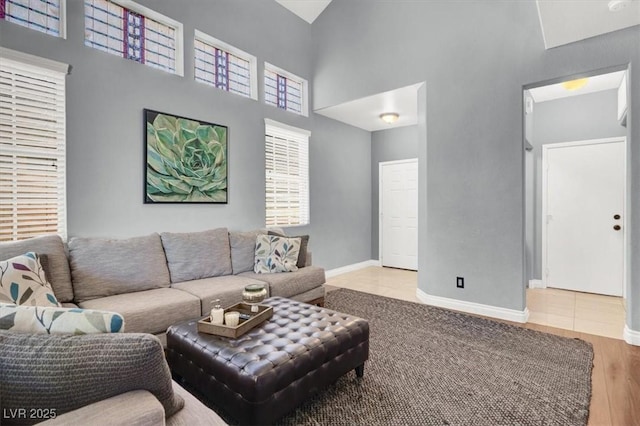 1861 Windward Ct, Henderson, NV 89012 - living room with baseboards, wood finished floors, and a towering ceiling