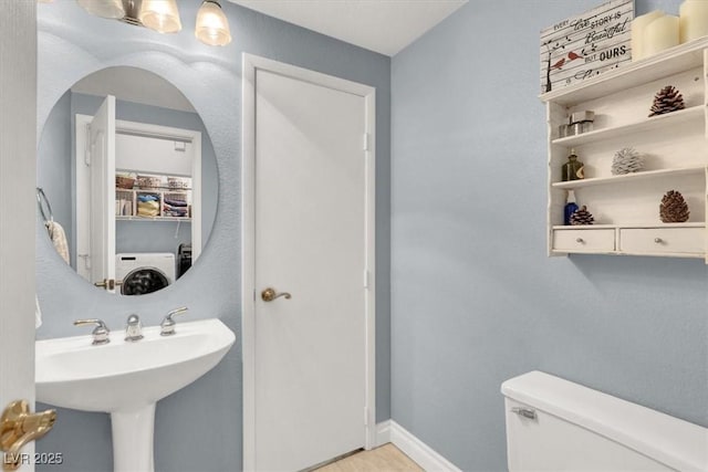1861 Windward Ct, Henderson, NV 89012 - half bathroom with a sink, washer / clothes dryer, and toilet