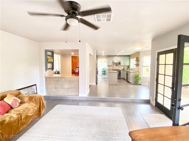 5381 Waving Sage Dr, Las Vegas, NV 89149 - living area featuring ceiling fan, light wood finished floors, and baseboards