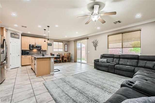living room with light tile patterned flooring, crown molding, recessed lighting, a ceiling fan, and baseboards