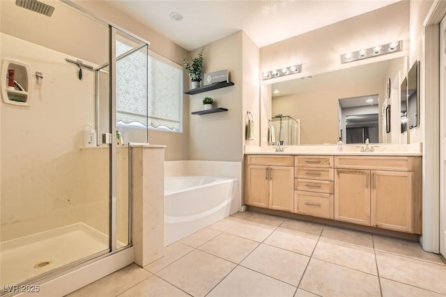 full bath with a stall shower, a bath, tile patterned floors, and double vanity