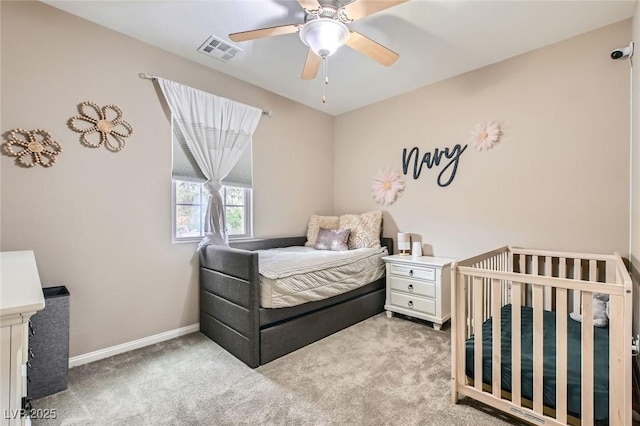 carpeted bedroom featuring baseboards and ceiling fan