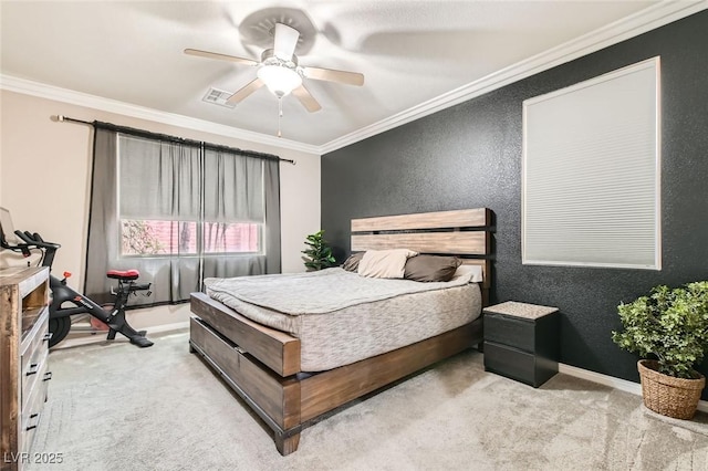 bedroom featuring light colored carpet, a textured wall, ornamental molding, baseboards, and a ceiling fan