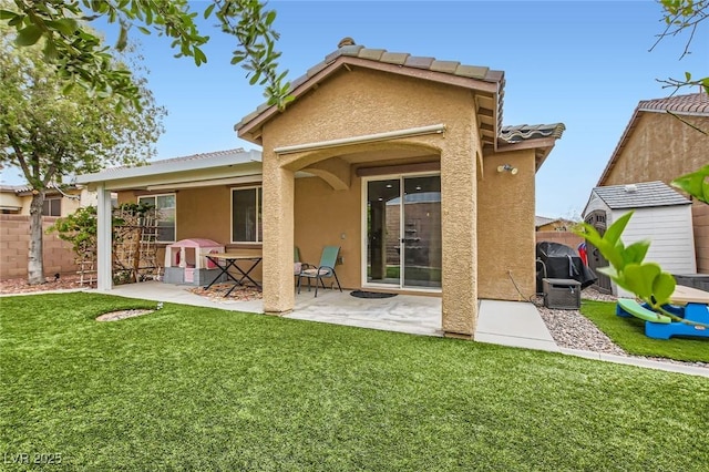 back of house featuring stucco siding, a patio area, and a tile roof