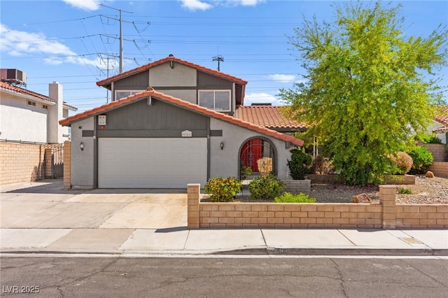 5361 Cabrito Dr, Las Vegas, NV 89103 - view of front facade with a tile roof, a garage, stucco siding, concrete driveway, and central air condition unit