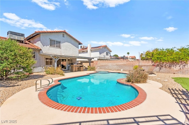 5361 Cabrito Dr, Las Vegas, NV 89103 - view of swimming pool with cooling unit, a patio, a fenced backyard, outdoor dry bar, and a fenced in pool