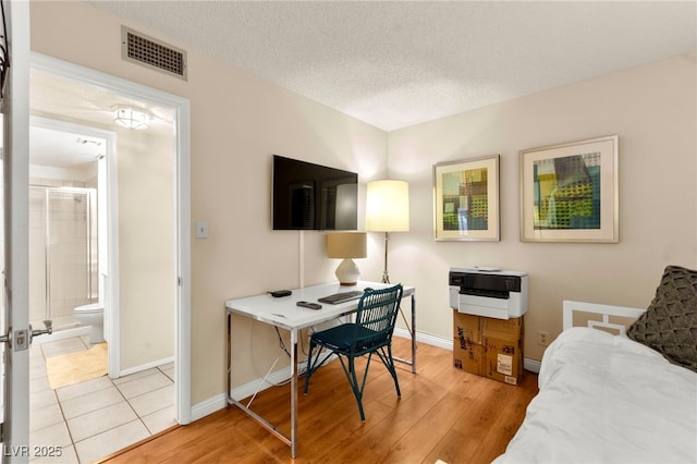 5361 Cabrito Dr, Las Vegas, NV 89103 - office with a textured ceiling, baseboards, visible vents, and light wood-style floors
