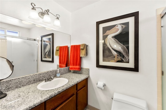 5361 Cabrito Dr, Las Vegas, NV 89103 - bathroom with vanity, a shower with shower door, and toilet