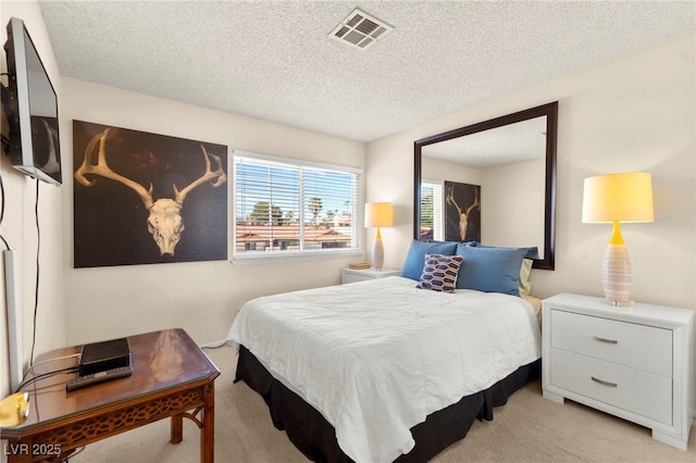 5361 Cabrito Dr, Las Vegas, NV 89103 - bedroom with a textured ceiling, visible vents, and light carpet