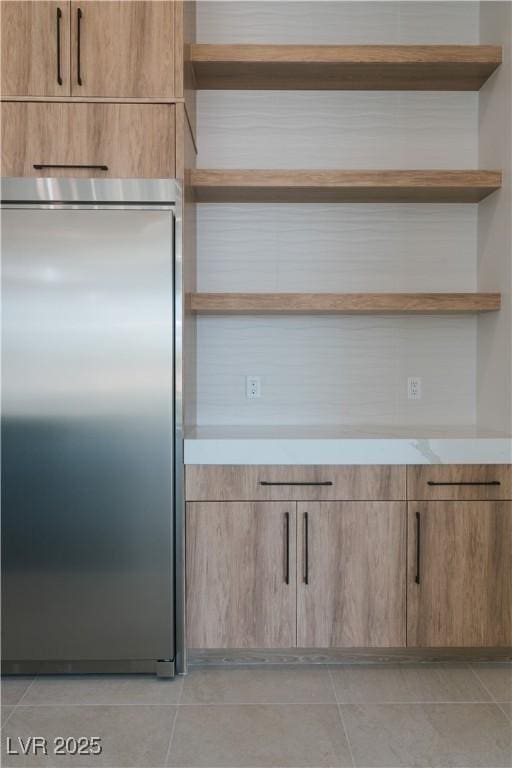 8721 Robinson Ridge Dr, Las Vegas, NV 89117 - kitchen with stainless steel built in fridge, open shelves, light tile patterned floors, light countertops, and modern cabinets