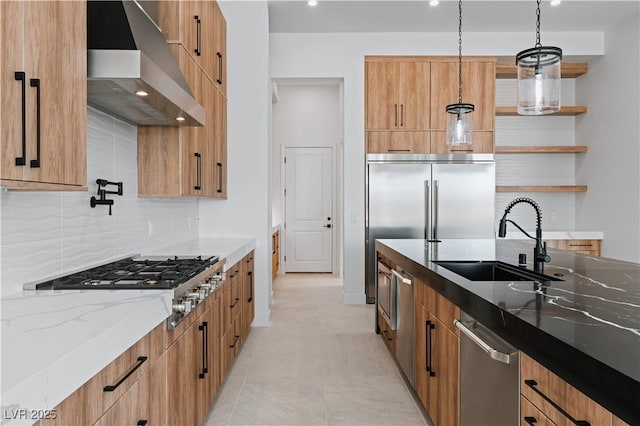 8721 Robinson Ridge Dr, Las Vegas, NV 89117 - kitchen with exhaust hood, stainless steel appliances, light stone counters, tasteful backsplash, and hanging light fixtures