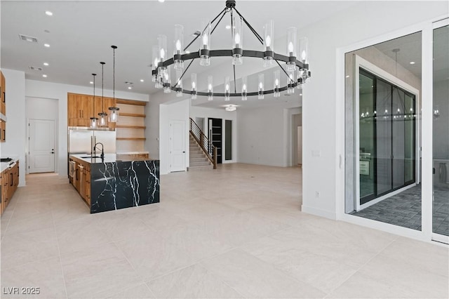 8721 Robinson Ridge Dr, Las Vegas, NV 89117 - kitchen featuring open shelves, a chandelier, open floor plan, pendant lighting, and a large island
