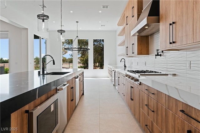 8721 Robinson Ridge Dr, Las Vegas, NV 89117 - kitchen with exhaust hood, modern cabinets, light tile patterned flooring, recessed lighting, and light stone countertops
