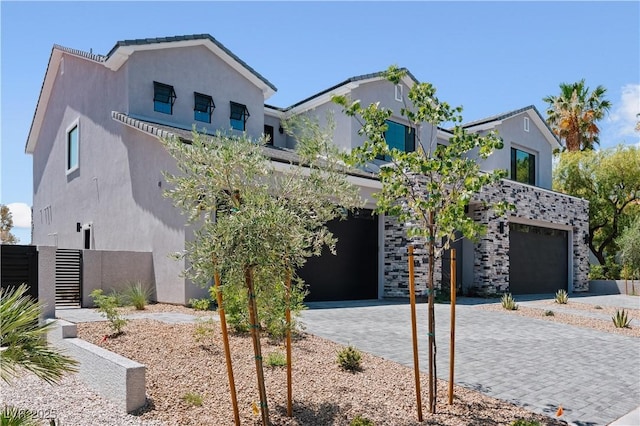 8721 Robinson Ridge Dr, Las Vegas, NV 89117 - view of front of home featuring decorative driveway, stucco siding, and a garage