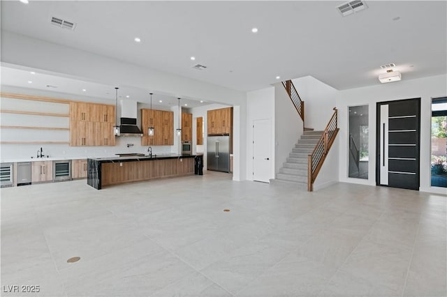 8721 Robinson Ridge Dr, Las Vegas, NV 89117 - unfurnished living room featuring beverage cooler, stairway, and recessed lighting