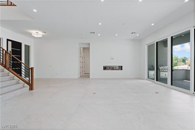 8721 Robinson Ridge Dr, Las Vegas, NV 89117 - unfurnished living room with stairs, recessed lighting, and a glass covered fireplace