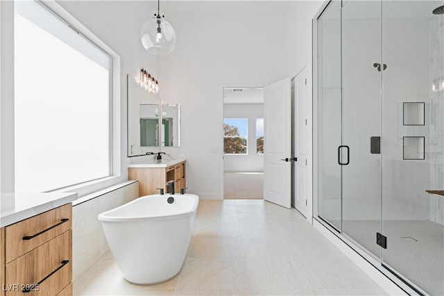 8721 Robinson Ridge Dr, Las Vegas, NV 89117 - full bathroom with a shower stall, vanity, and a freestanding bath
