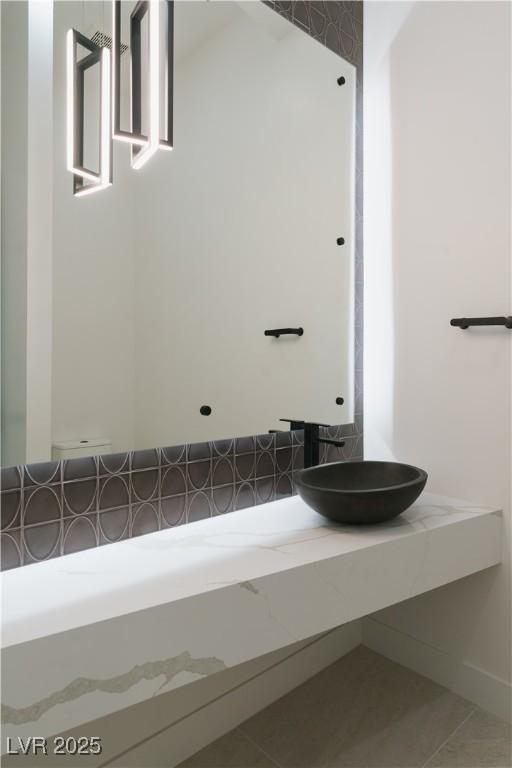 8721 Robinson Ridge Dr, Las Vegas, NV 89117 - bathroom featuring tile patterned floors and decorative backsplash