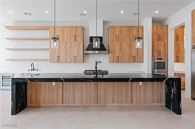 8721 Robinson Ridge Dr, Las Vegas, NV 89117 - kitchen with wall chimney exhaust hood, open shelves, backsplash, a spacious island, and recessed lighting