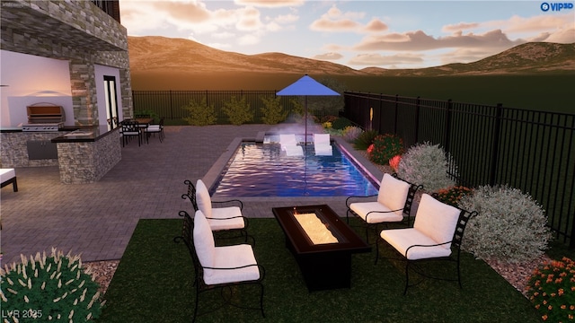 8721 Robinson Ridge Dr, Las Vegas, NV 89117 - view of pool featuring a mountain view, an outdoor kitchen, a fire pit, a fenced backyard, and a patio area