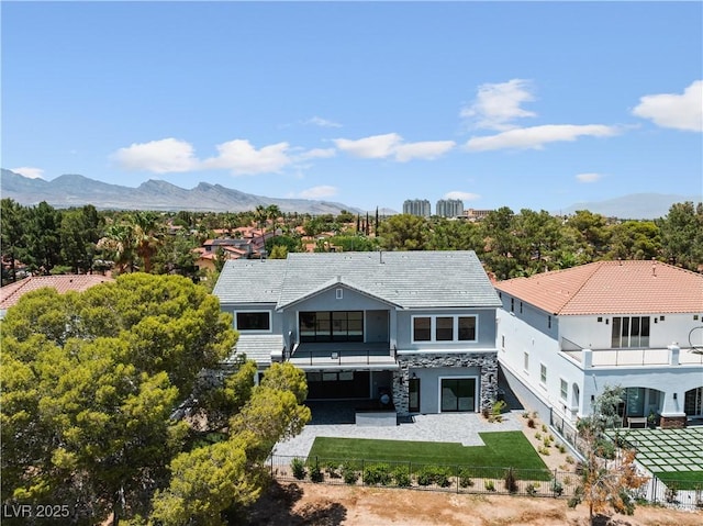 8721 Robinson Ridge Dr, Las Vegas, NV 89117 - rear view of property with a balcony, stucco siding, stone siding, and a mountain view