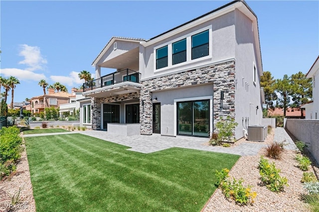 8721 Robinson Ridge Dr, Las Vegas, NV 89117 - back of property with a balcony, stone siding, stucco siding, and a patio