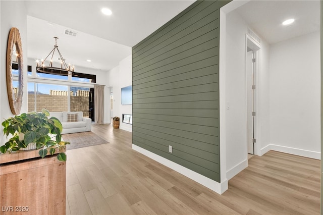 9815 Evergreen Pine St, Las Vegas, NV 89166 - corridor with a chandelier, baseboards, visible vents, and light wood finished floors
