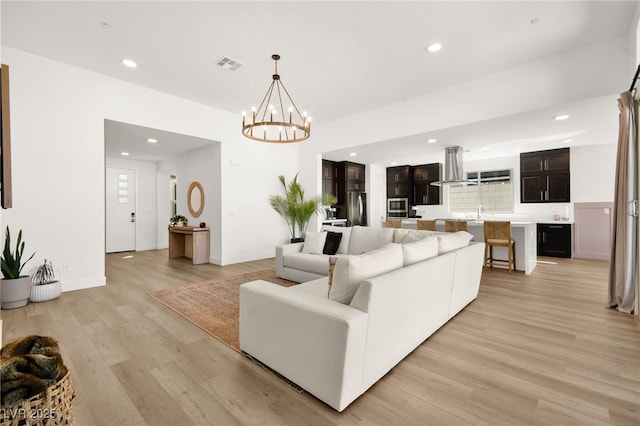 9815 Evergreen Pine St, Las Vegas, NV 89166 - living room featuring visible vents, light wood-type flooring, baseboards, a notable chandelier, and recessed lighting