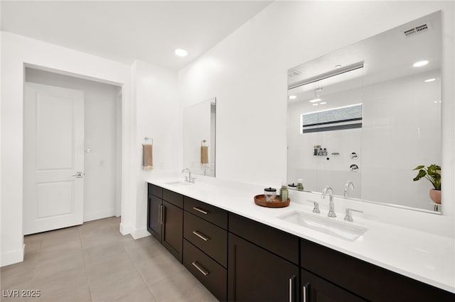 9815 Evergreen Pine St, Las Vegas, NV 89166 - bathroom featuring visible vents, a sink, tile patterned flooring, and double vanity