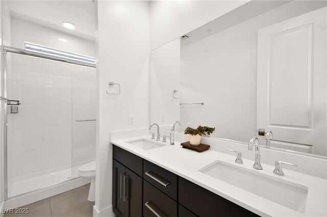 9815 Evergreen Pine St, Las Vegas, NV 89166 - bathroom featuring double vanity, toilet, tile patterned floors, and a sink