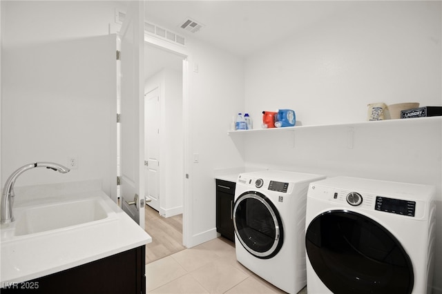 9815 Evergreen Pine St, Las Vegas, NV 89166 - laundry area featuring a sink, visible vents, cabinet space, and washer and clothes dryer