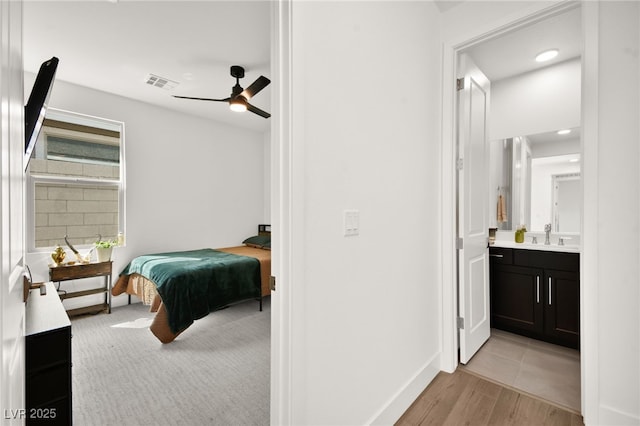 9815 Evergreen Pine St, Las Vegas, NV 89166 - bedroom featuring connected bathroom, a sink, light wood-style floors, baseboards, and visible vents