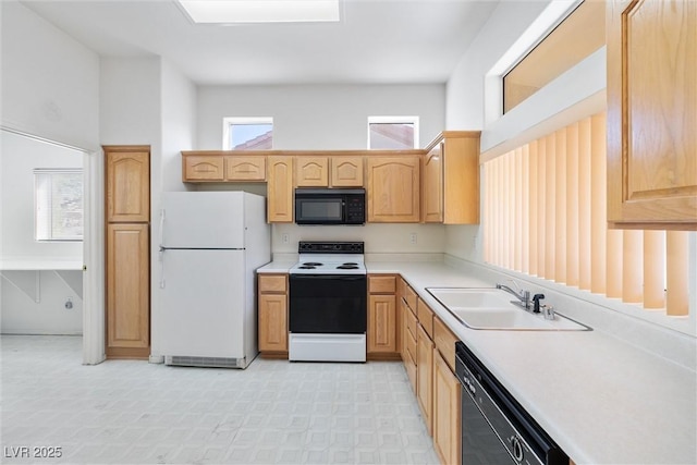 kitchen with light brown cabinetry, a sink, light countertops, black appliances, and light floors