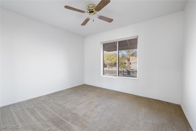 spare room with carpet floors and a ceiling fan