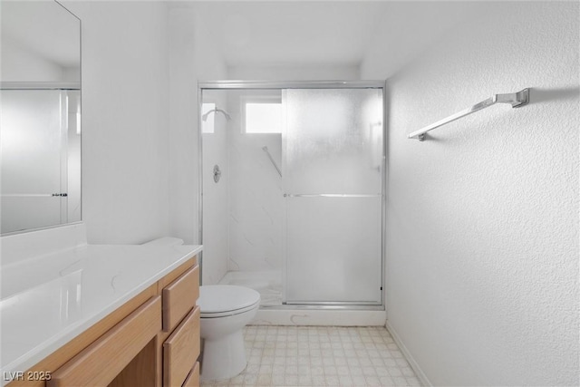 full bath featuring vanity, a stall shower, tile patterned floors, and toilet
